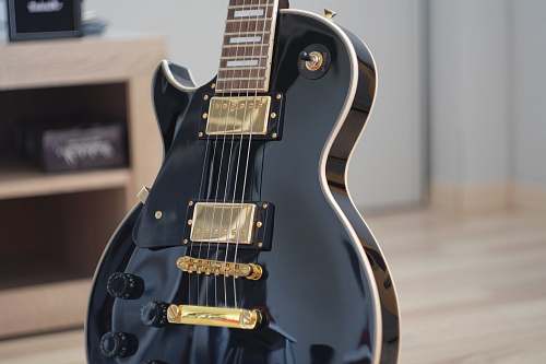 electric guitar macro shot photo of black electric guitar guitar
